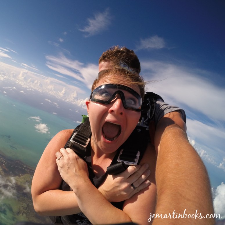 Image of a woman shouting with wide eyes during a sky dive